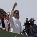 Supporters of Imran Khan flung rose petals at the convoy transporting