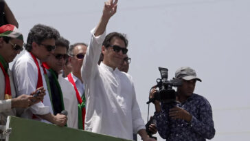 Supporters of Imran Khan flung rose petals at the convoy transporting