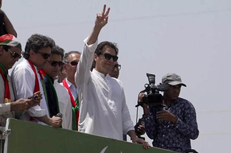 Supporters of Imran Khan flung rose petals at the convoy transporting